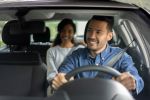 Driver transporting a woman in a car while talking to her - transportation concepts