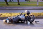 motorcycle laying down on road after accident concept